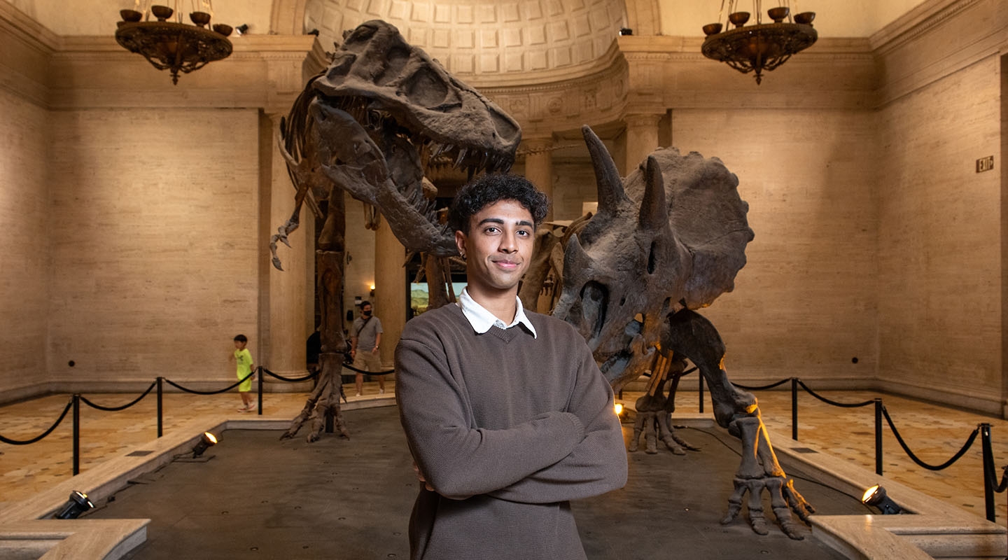 Oxy student standing in front of an exhibit at the Natural History Museum