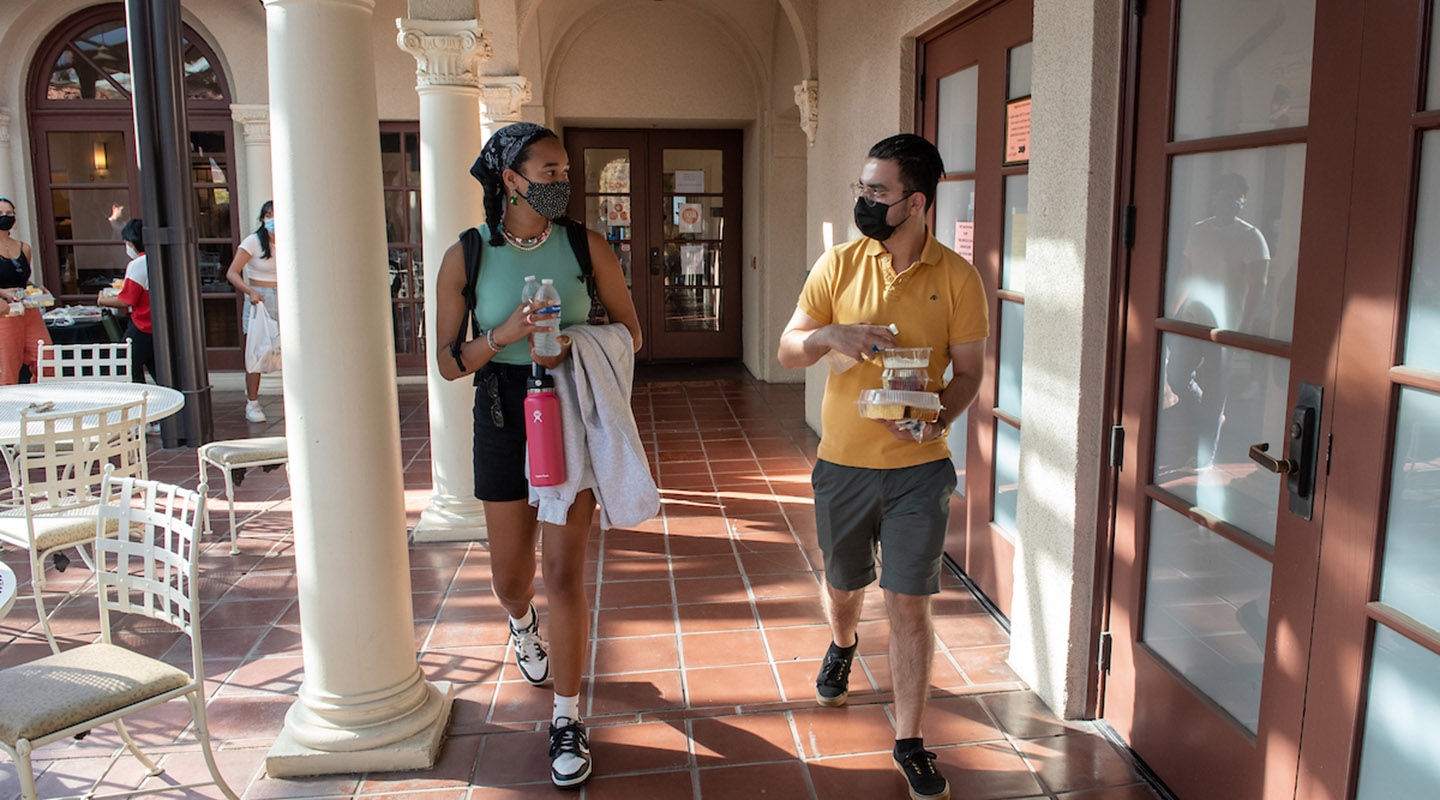 Two students with masks on campus