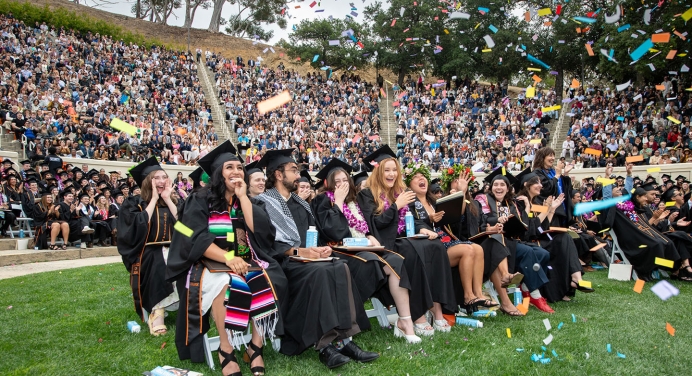 Occidental College graduates on graduation day celebrating in their seats