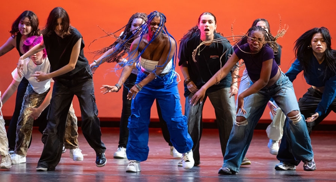 Dance Pro student dancers doing a hip hop routine with a red background