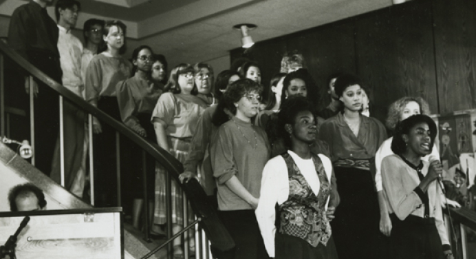 The Occidental Gospel Choir, with soloist Jacqui (Dent) Ivey '92 M'95 (foreground), performs in January 1991.