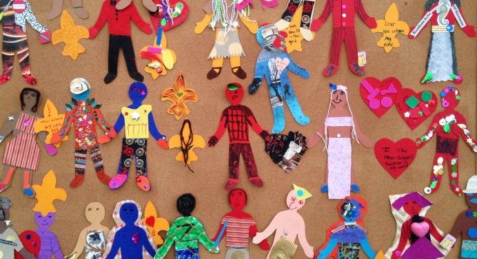 Colorful picture of children&#039;s artwork depicting different figures in brightly colored outfits. 