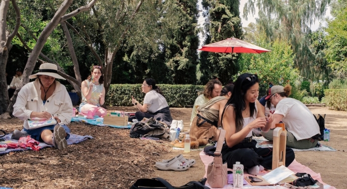 wide color photo of people doing crafts in a garden