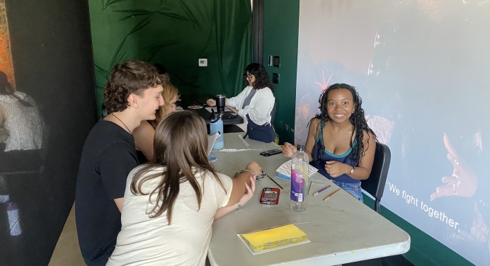 color image of four people creating books at an arts workshop
