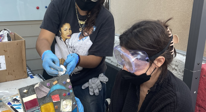 color image of a workshop participant making a mosaic