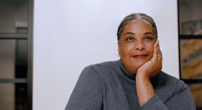 Bestselling author Roxane Gay headshot in grey sweater