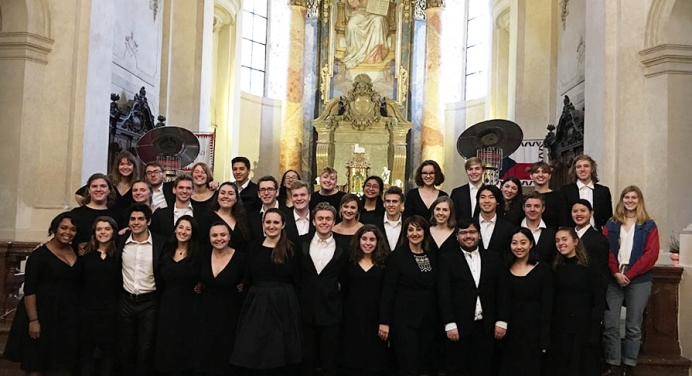 The Glee Club posing inside of a church