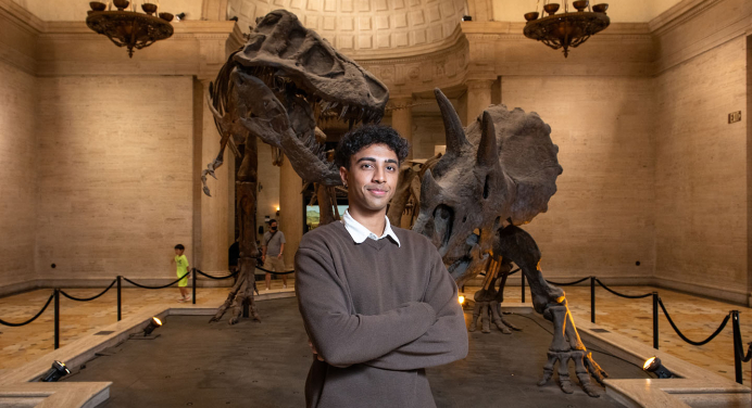 Oxy student standing in front of an exhibit at the Natural History Museum