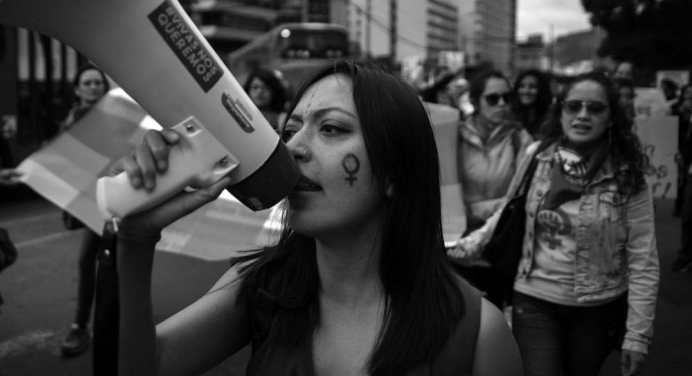 black and white photo of women protesting gender based violence in the street