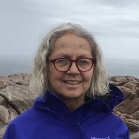 Woman in front of rocks and sky
