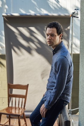 Instructor Max Foreman standing next to a chair