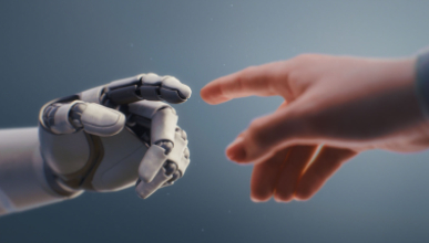 a robot hand reaching out to touch a human hand
