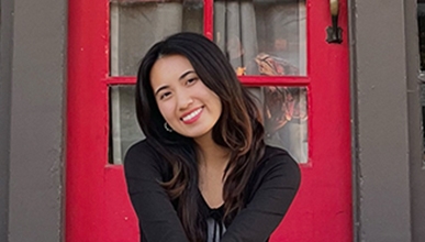 Reyan Nguy sits in front of the Intercultural Community Center at Occidental College