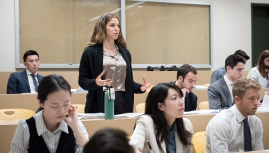 an Occidental College classroom of students and a young woman standing up to talk