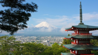 a view of Mt Fuji in Japan with traditional red pagoda building in foreground