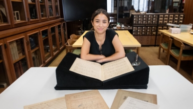 Francesca Rodoni '24 examining a musical manuscript of Franz Liszt