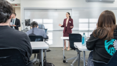 Occidental College professor Marisol Leon standing in front of a classroom of students, talking