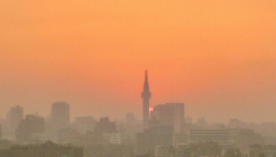 A sunset over the Cairo skyline, showcasing the city's iconic minarets