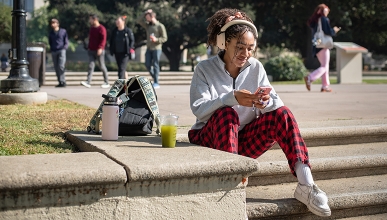 An Occidental student checks messages in between classes