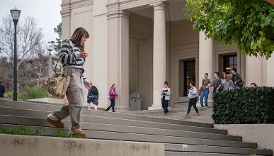 A student walks down steps on the Occidental College campus