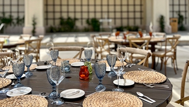 Tables arranged with table settings in a courtyard