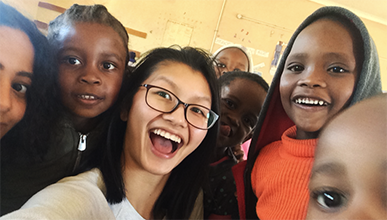 Oxy student with children in Botswana