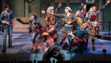 actors on a stage, all in dramatic poses