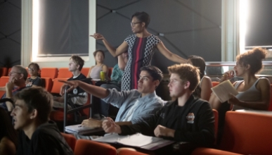 Students in a classroom with a professor lecturing