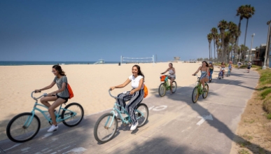 Students bike along the beach in Santa Monica.