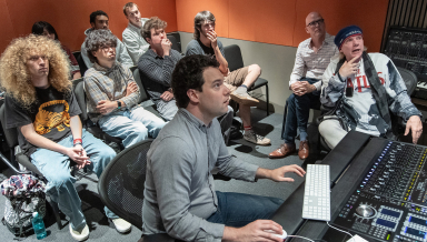 Curb Visiting Fellow Michael Lloyd, far right, and Resident Assistant Professor Max Foreman with Oxy students in the Choi Family Music Production Center.
