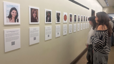 Spectators view the OCLAA oral history gallery in the Academic Commons in February 2024.