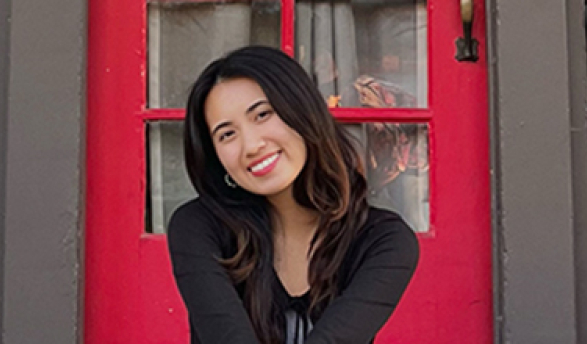 Reyan Nguy sits in front of the Intercultural Community Center at Occidental College