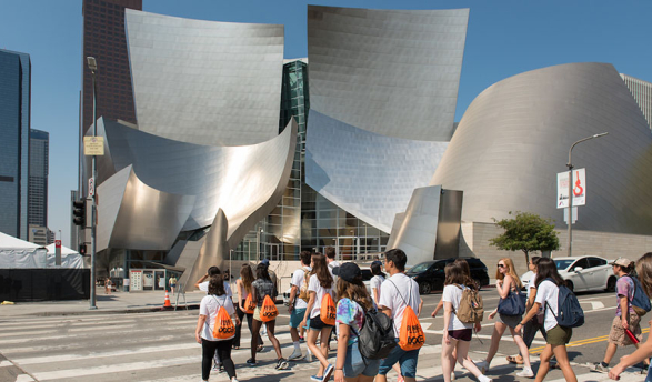Occidental College students walking across Grand Avenue in LA to the sculptural Disney Concert Hall