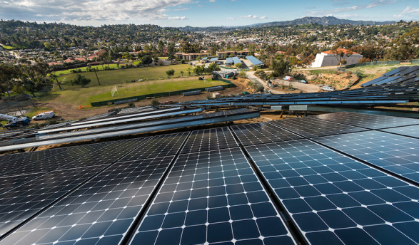 A slanting view of Occidental's solar array with campus in the far background