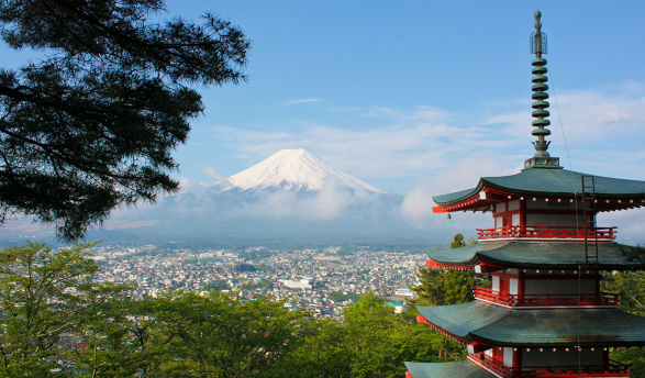 a view of Mt Fuji in Japan with traditional red pagoda building in foreground