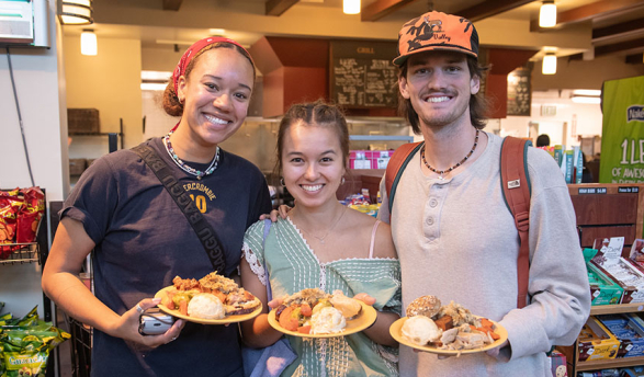 Three Occidental College students enjoying the food in the Marketplace dining location on campus