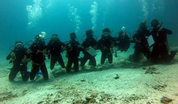 a group of underwater sea divers on the ocean floor