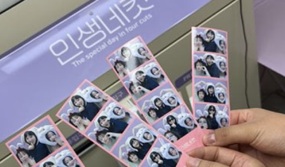 A close-up of photo booth photo strips showing friends posing together