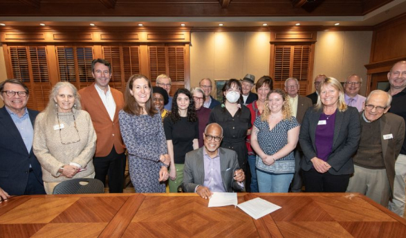 President Harry J. Elam, Jr. signs the Second Nature Climate Pledge