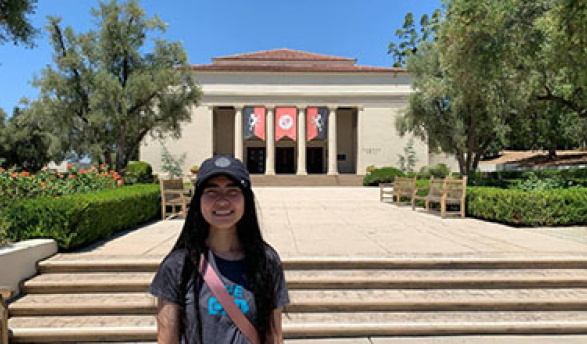 Oxy student Thina Ly stands in front of Thorne Hall on campus
