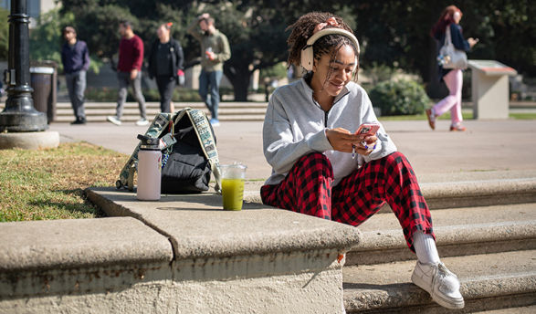 An Occidental student checks messages in between classes