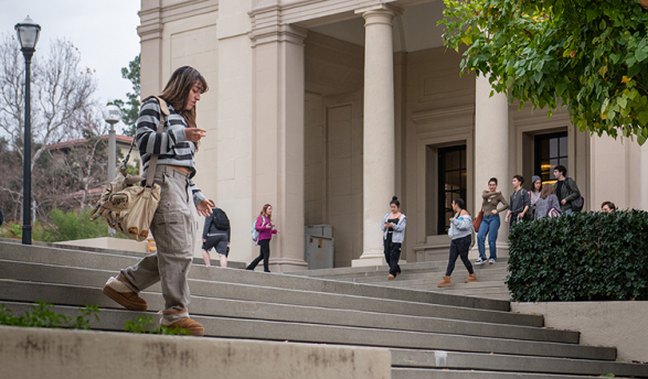 A student walks down steps on the Occidental College campus
