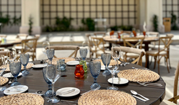 Tables arranged with table settings in a courtyard