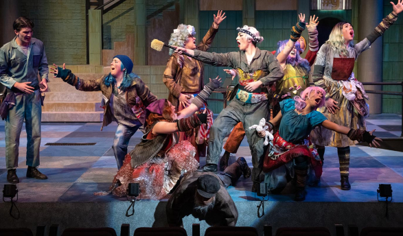 actors on a stage, all in dramatic poses