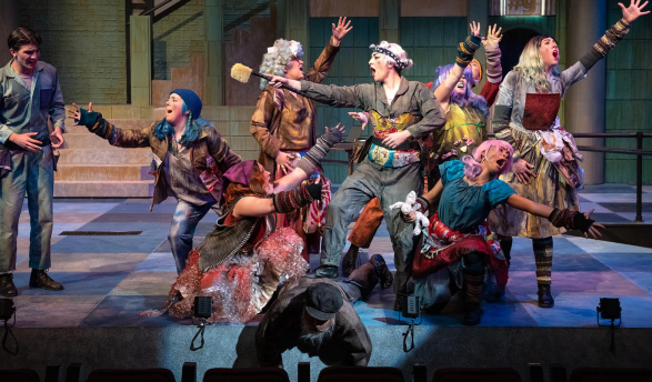 actors on a stage, all in dramatic poses
