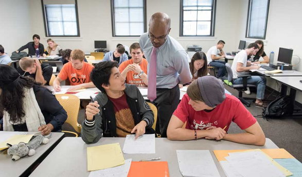 Students asking a professor questions