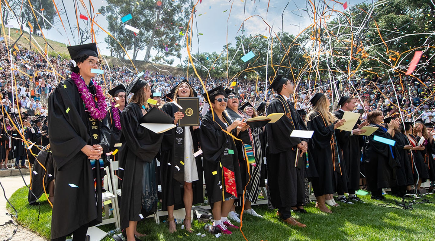 Graduates from the Class of 2023 stand in the Greek Bowl with confetti