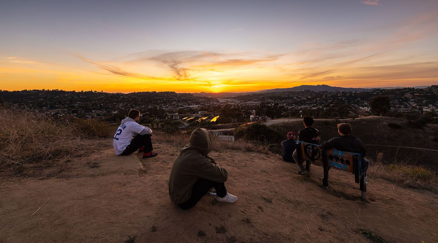 A view of students watching the sunset from Fiji Hill on the Occidental College campus