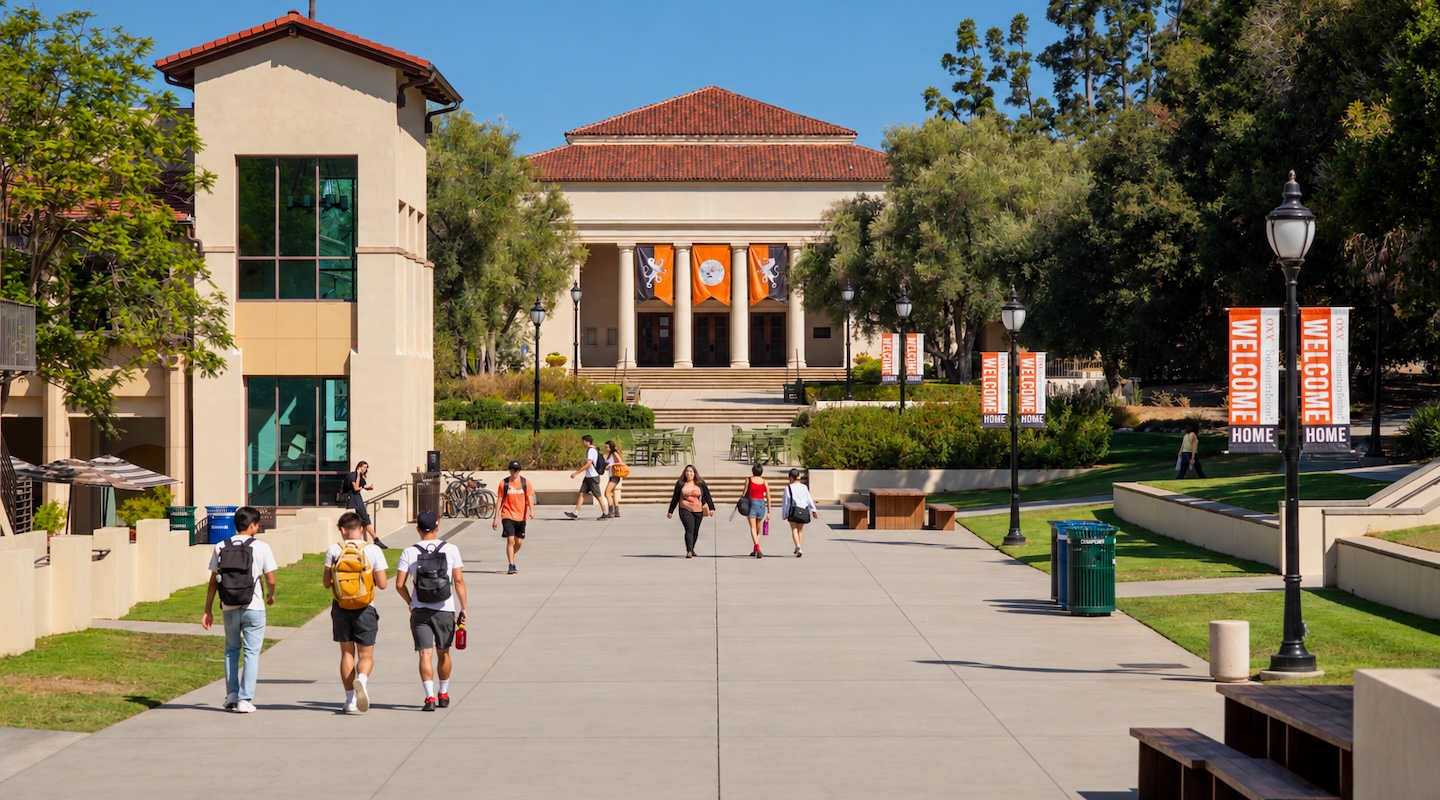 A view of Thorne Hall on campus with students walking down the sidewalk