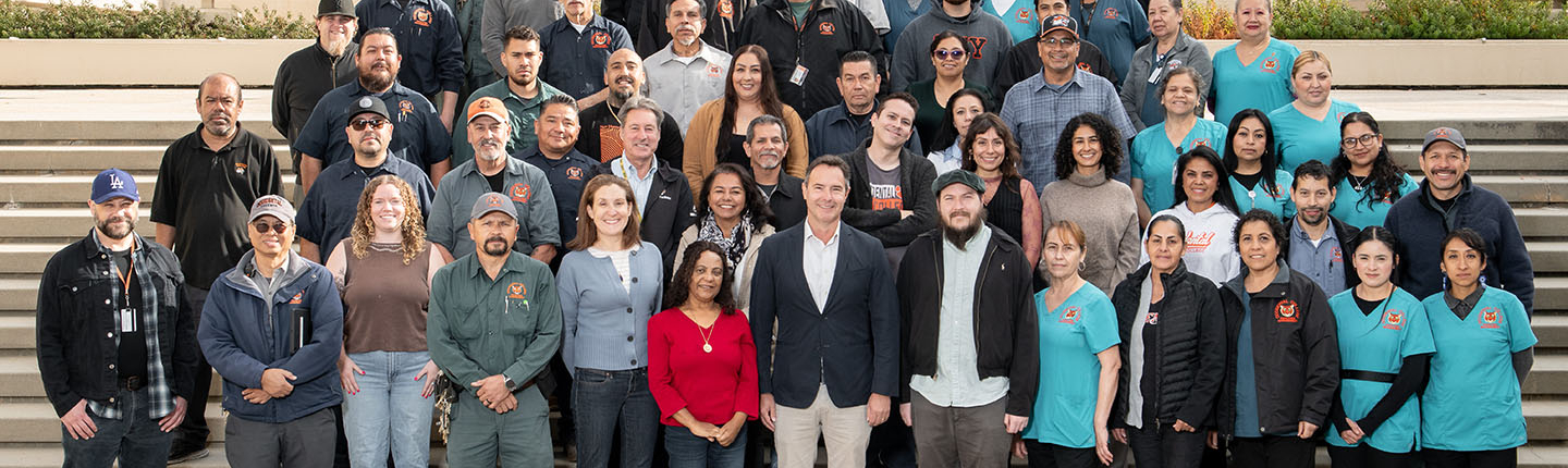 A large group of Facilities Management staff on the steps at Occidental College